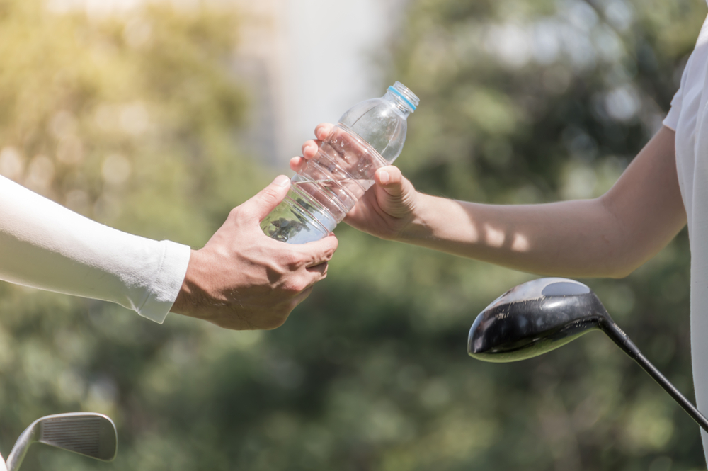 Athlete handled bottled water on the golf course