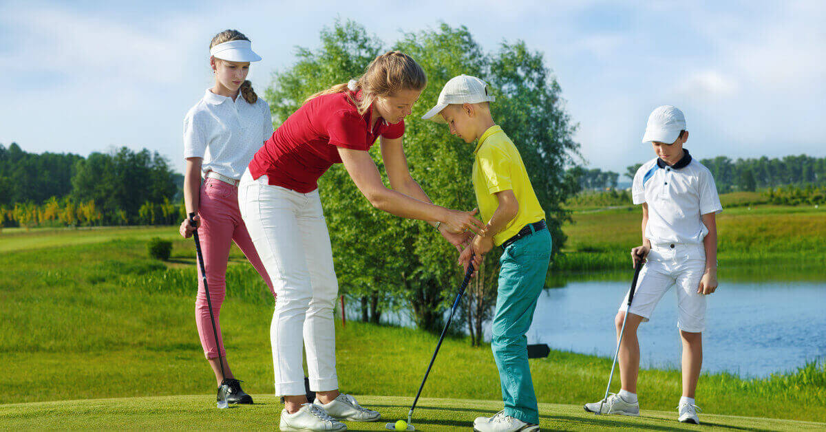 kids learning golf techniques at summer golf camp