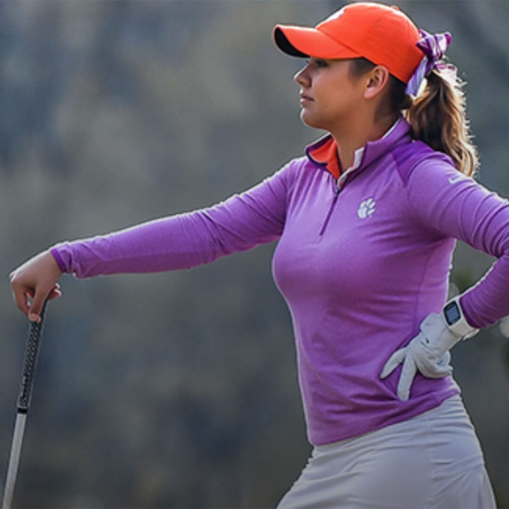 Side profile of golfer Anan Paula Valder, as she leans on her golf club