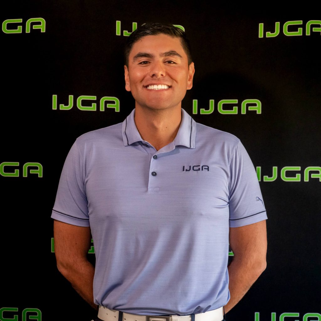 IJGA coach Camilo Castiblanco, smiles against a black IJGA logo background