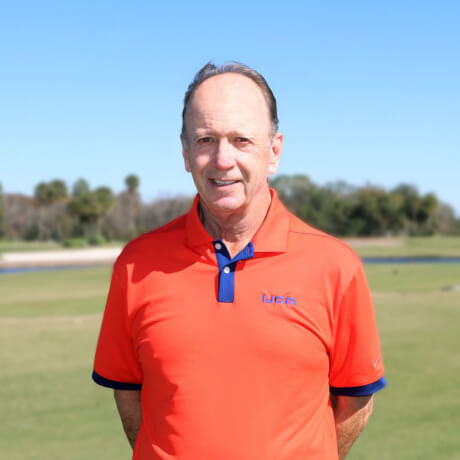 IJGA coach, Fred Griffin stands on the golf course