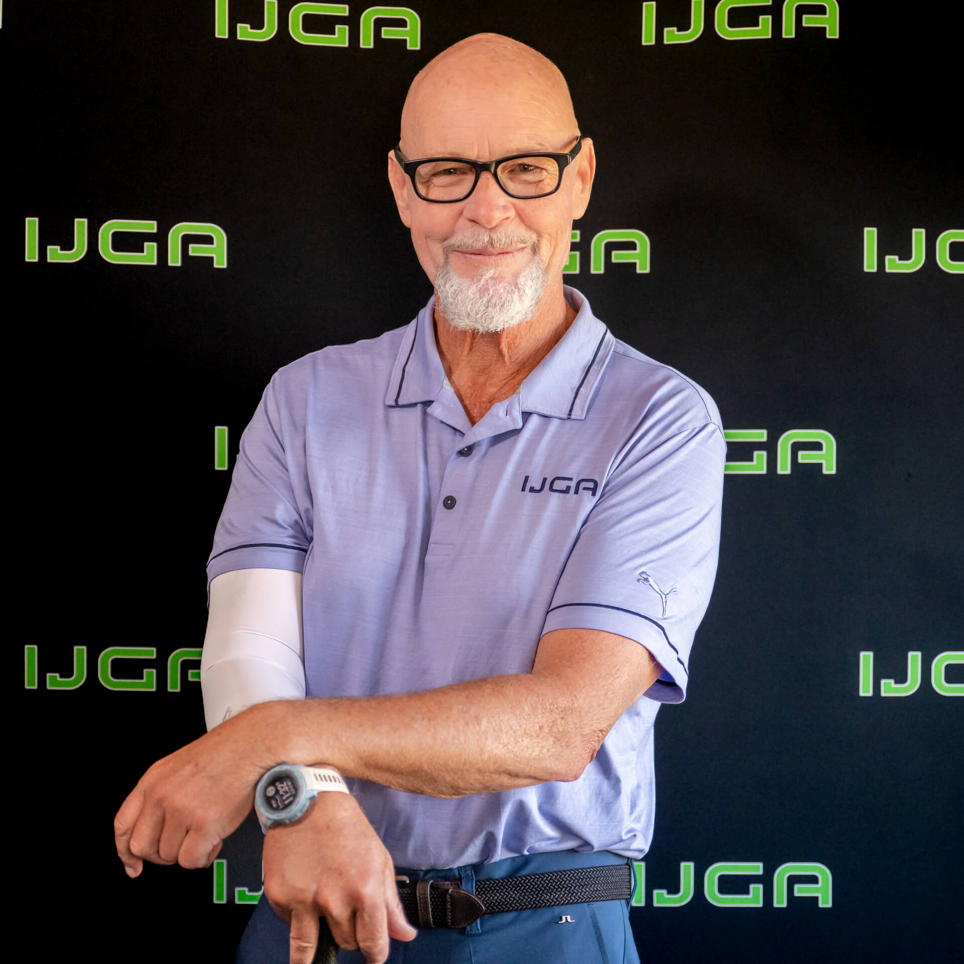 IJGA coach Gary Wise, smiles against a black IJGA logo background