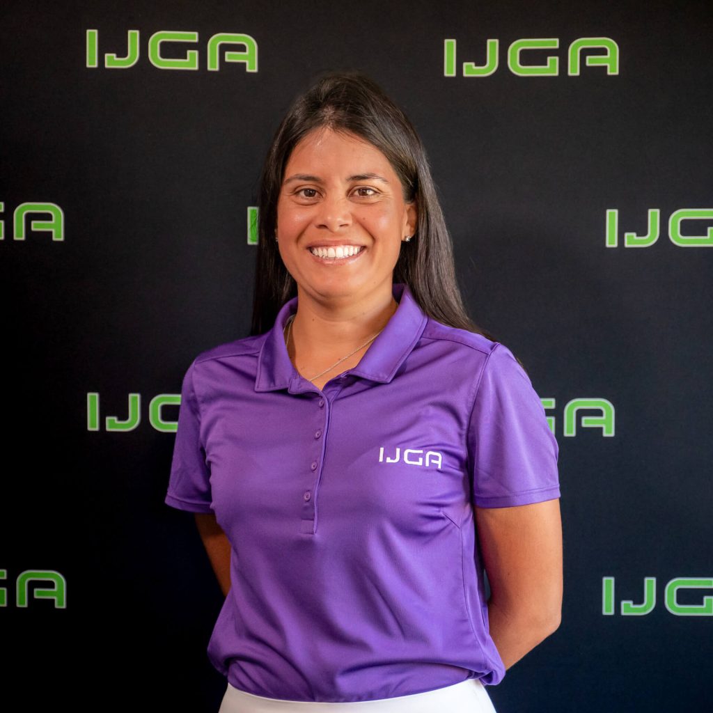 IJGA coach Julieta Granada, smiles against a black IJGA logo background