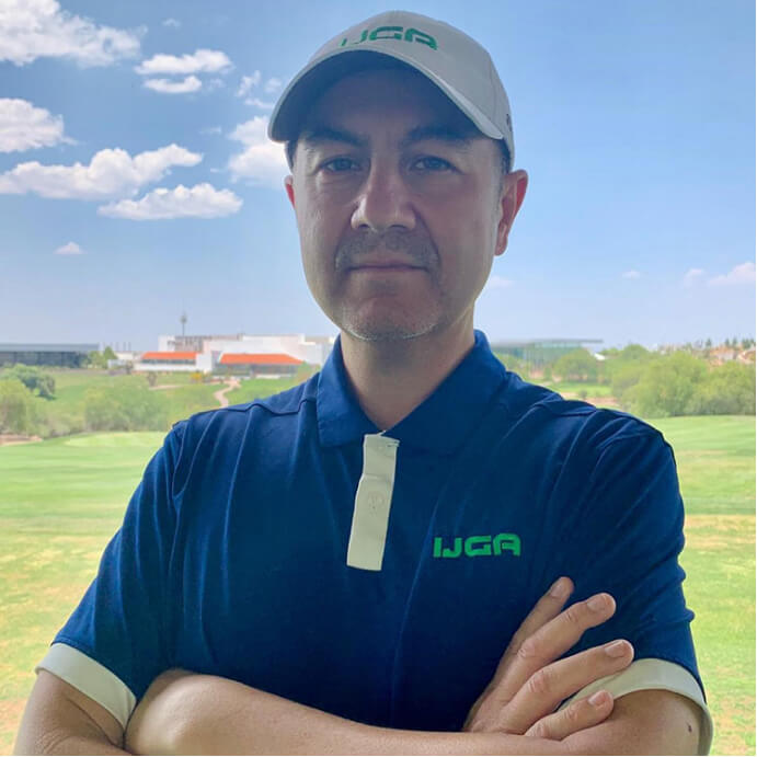 IJGA coach, Oscar Palacio standing on golf course