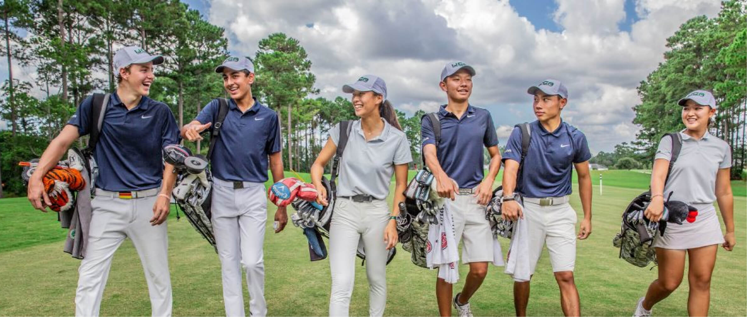 Group of IJGA golfers smile and walk together on the golf course