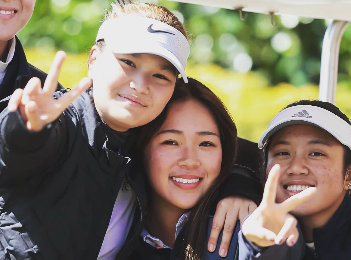 Group picture of smiling female golf students.